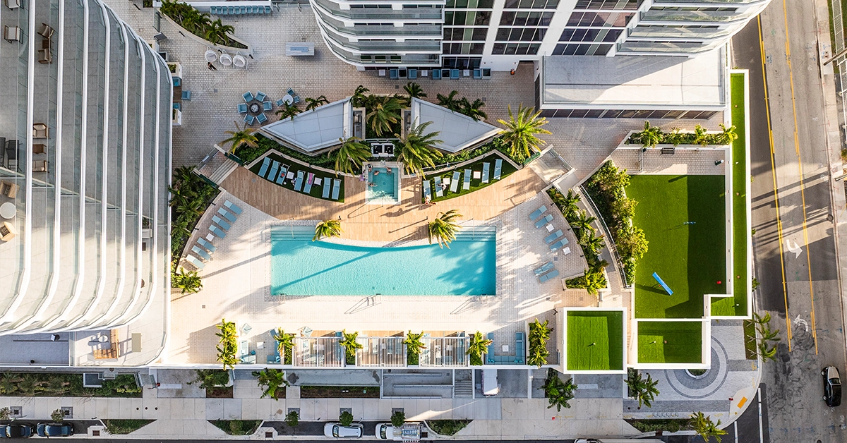Top-down aerial view of elevated pool terrace with lounge chairs and landscaped deck.