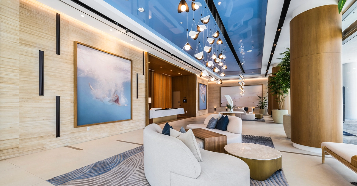 Modern luxury condo lobby with contemporary seating and pendant lighting.