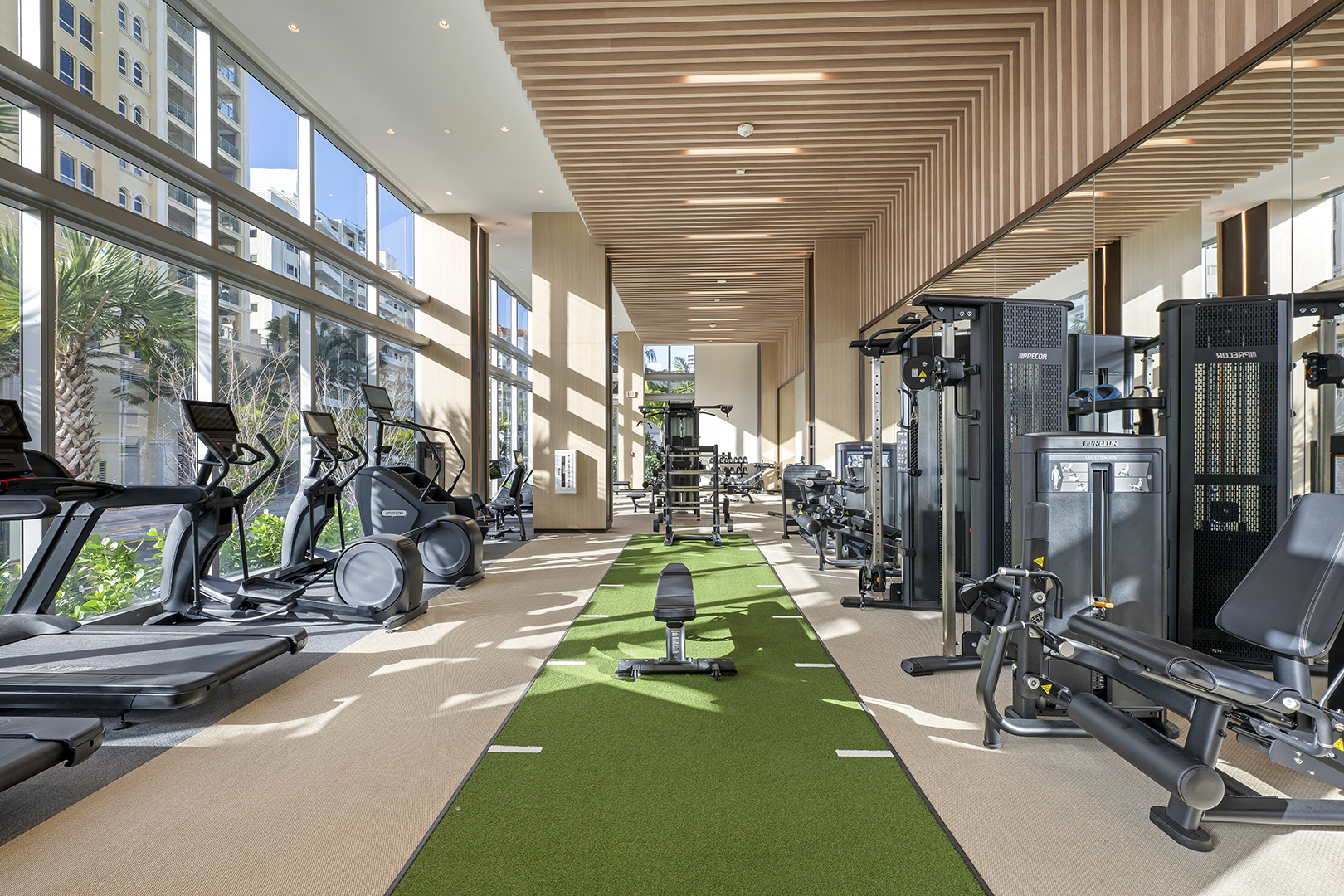 Fitness center at Selene Fort Lauderdale with gym equipment and windows