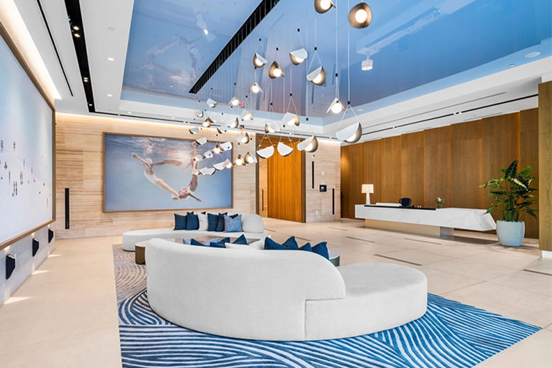 Elegant lobby with curved seating, chandelier lights, and reception desk